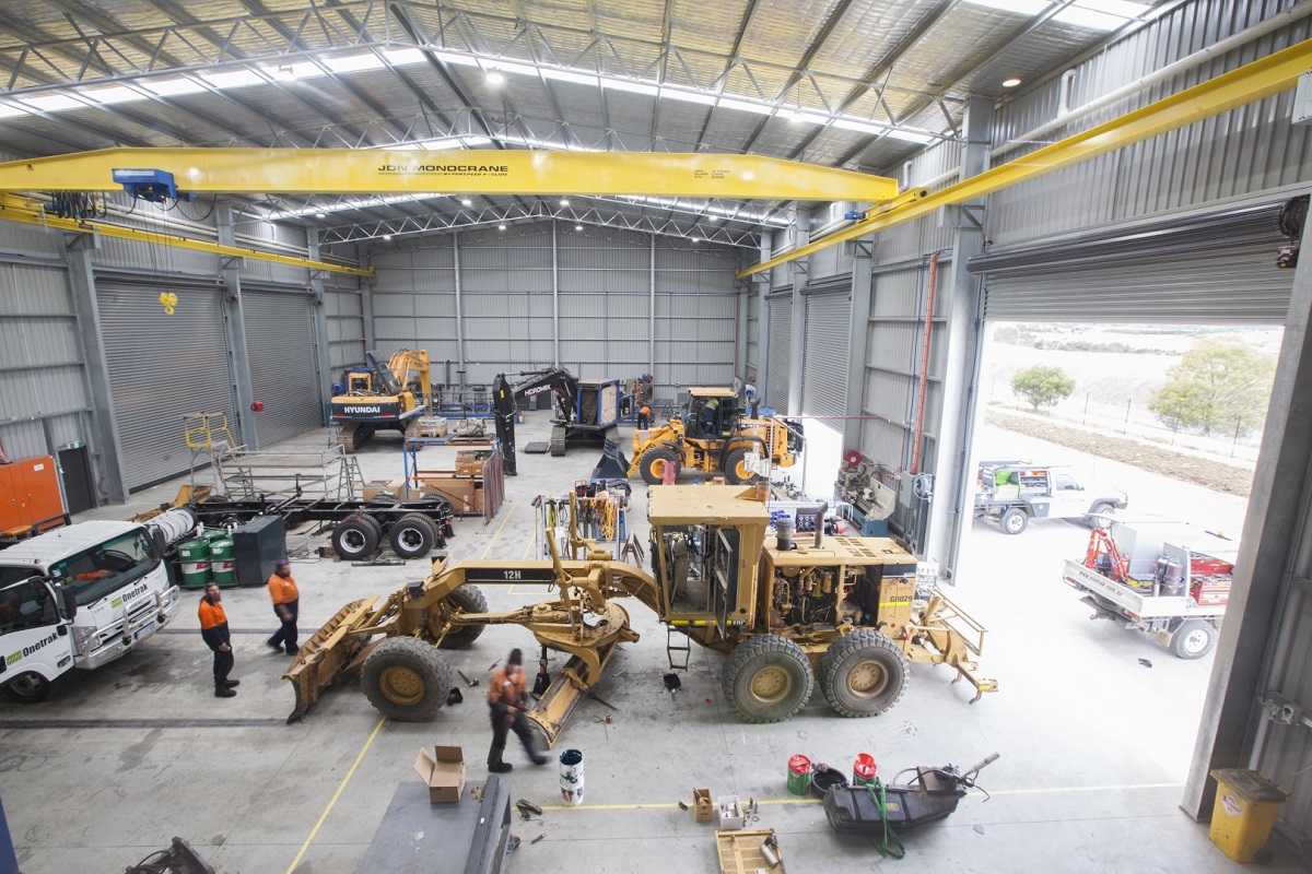 Heavy machinery workshop construction for ONETRAK with overhead cranes and graders under maintenance
