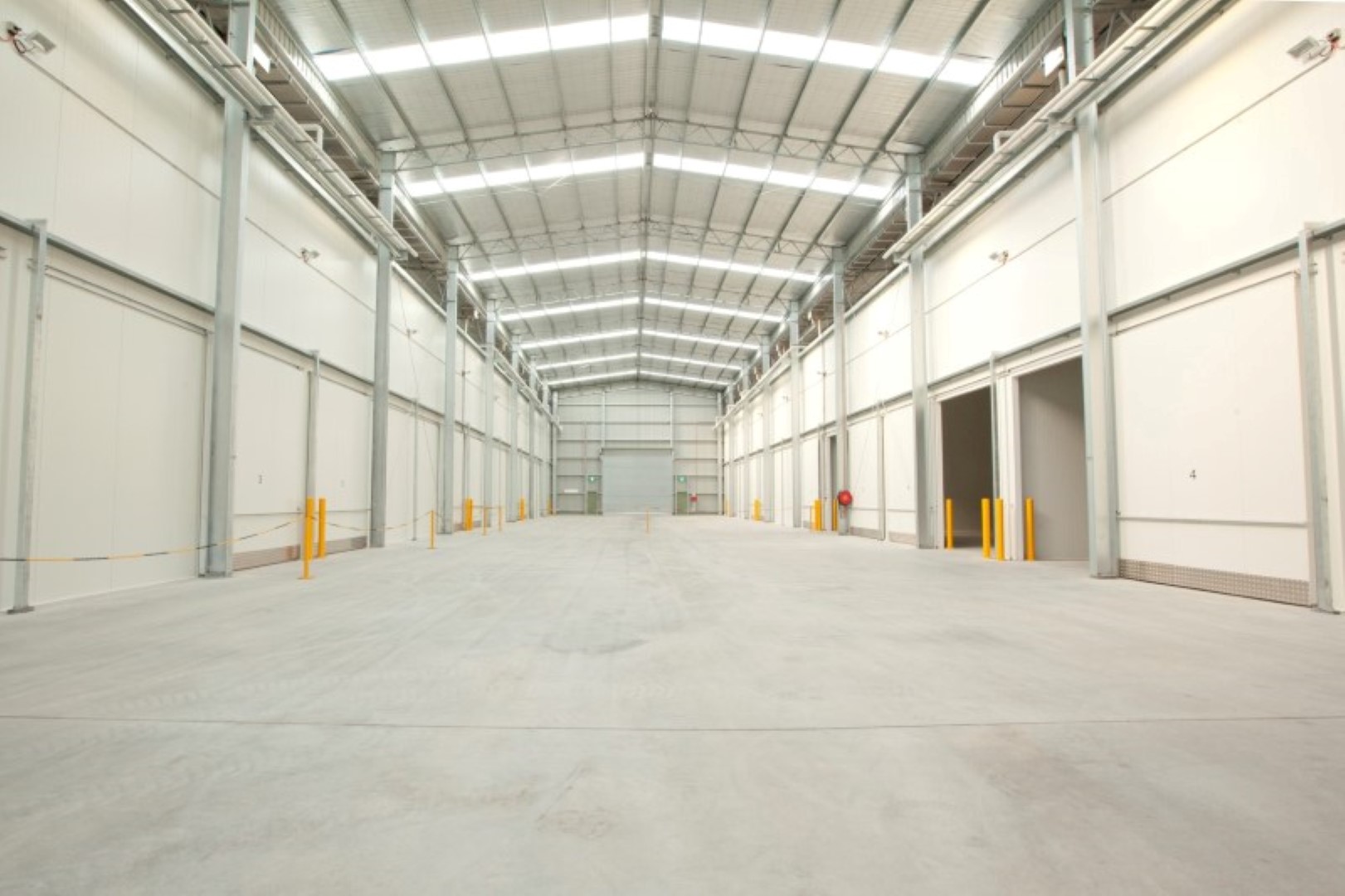 Interior cold storage warehouse with insulated panel walls and high-clearance doors - Agronico Latrobe