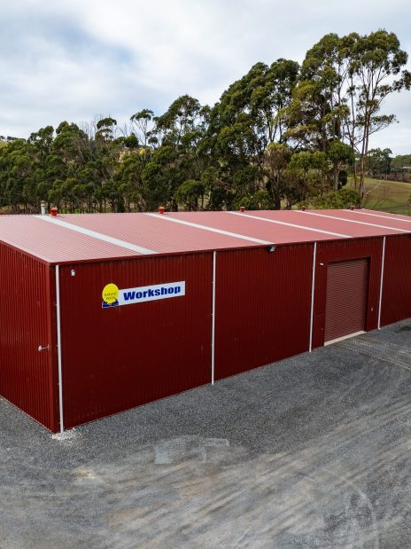 Custom-built steel workshop shed with red cladding in Tasmania