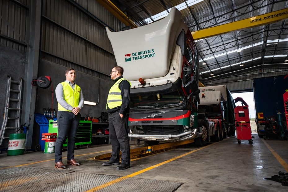 Transport workshop construction with trucks under repair and service pits