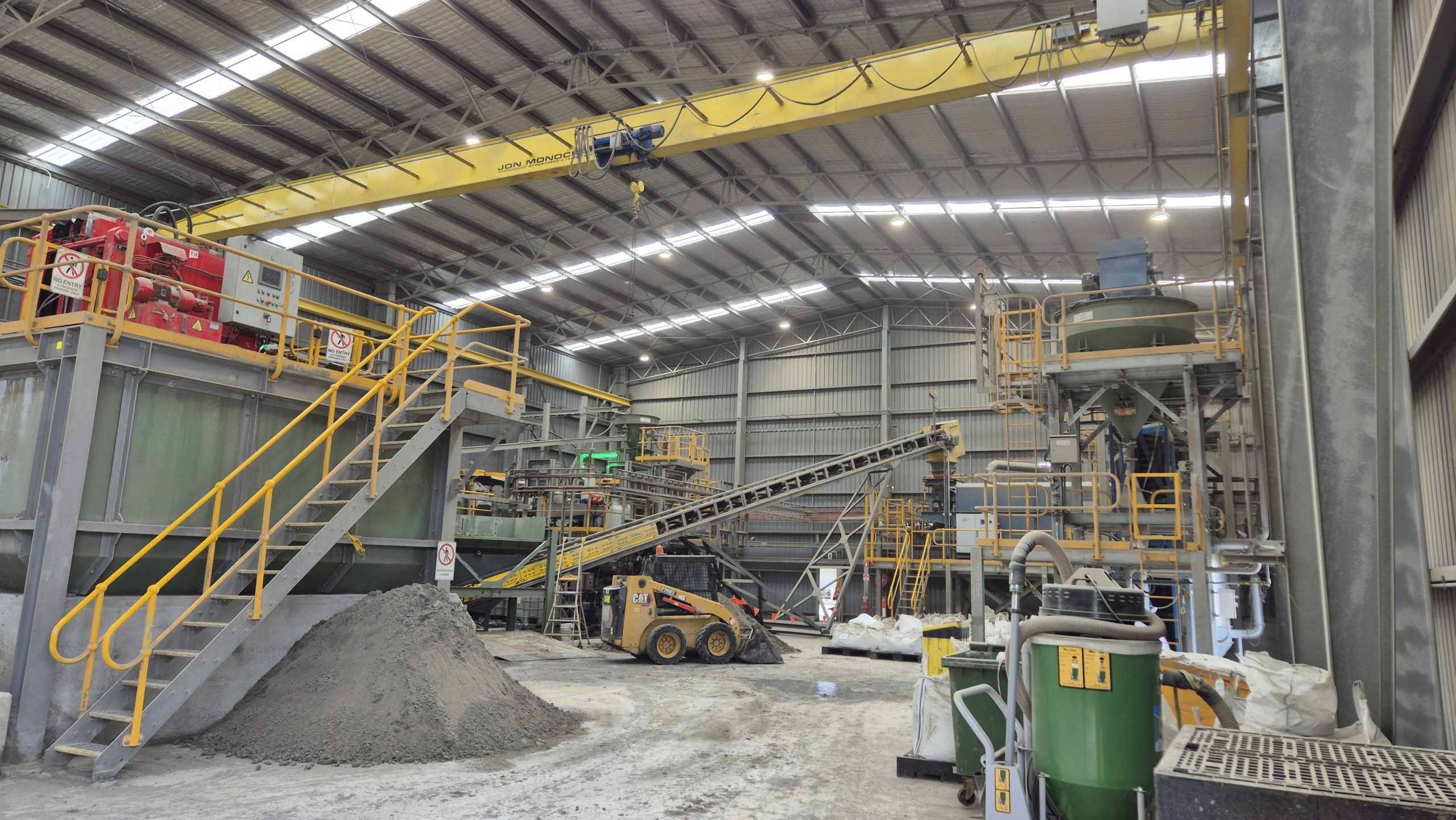 Interior of industrial building Tasmania featuring heavy machinery and crane systems